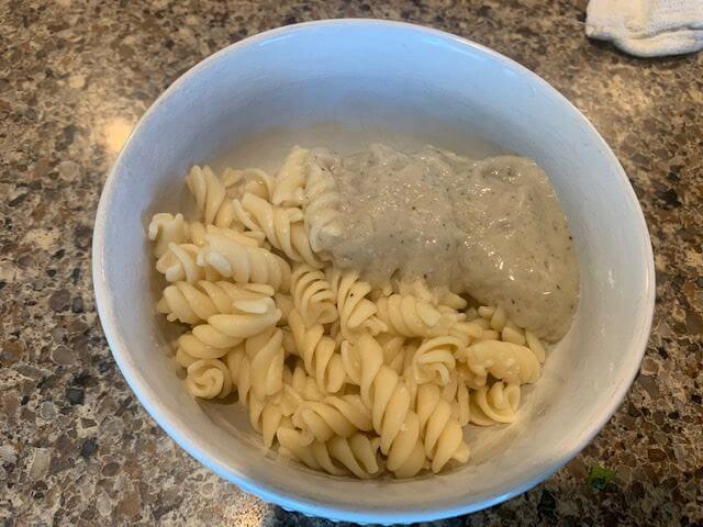 primal kitchen alfredo sauce poured on pasta