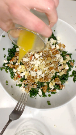 Pour apple, walnuts, cheese, and the rest of your dressing and toss