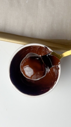 Dip each coconut ball in the chocolate and remove with a fork, let excess chocolate drip off.