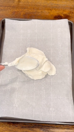 Transfer yogurt combination onto parchment-lined cookie sheet.