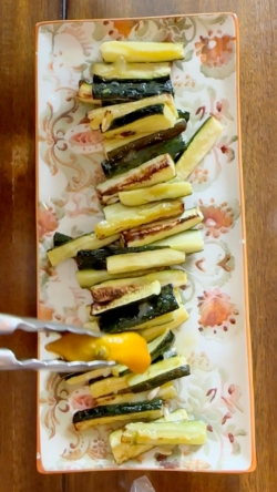 With tongs, squeeze cooked lemon over the top of the zucchini as the lemon will be hot!