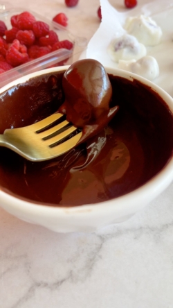 Melt the chocolate chips in a microwave-safe bowl. Dip each berry in the chocolate until it's covered and place it back on the plate.