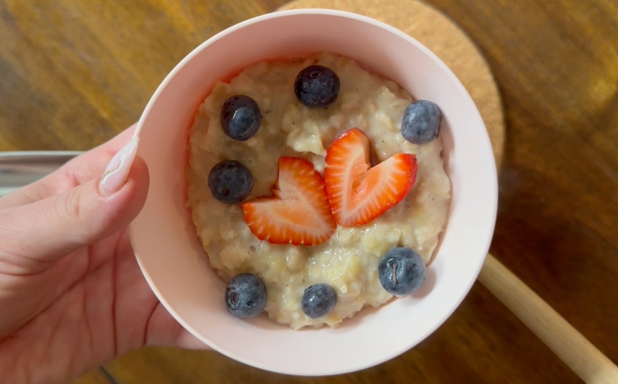 serving oatmeal topped with fresh berries
