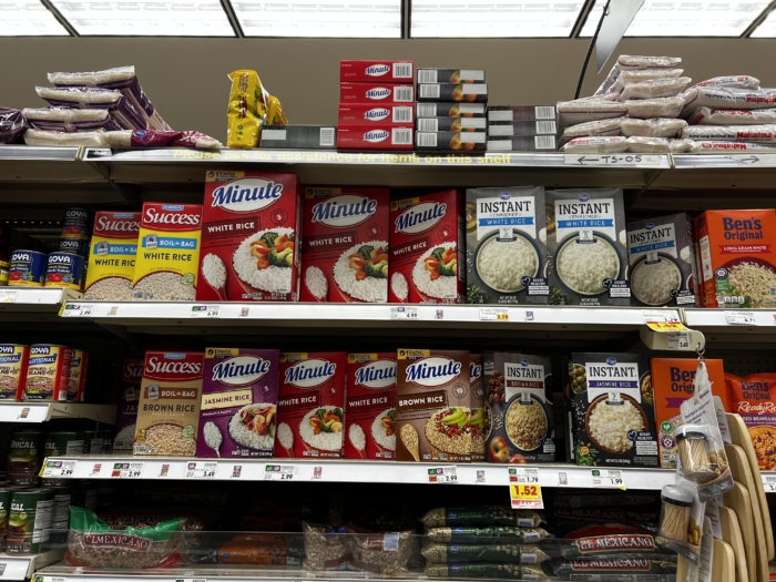 Boxes of white rice at the grocery store.